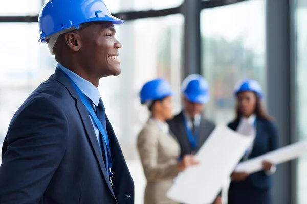 Engineering and construction professionals reviewing plans on site